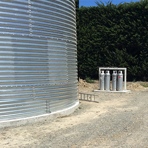 Gas bottles outside silo in yard